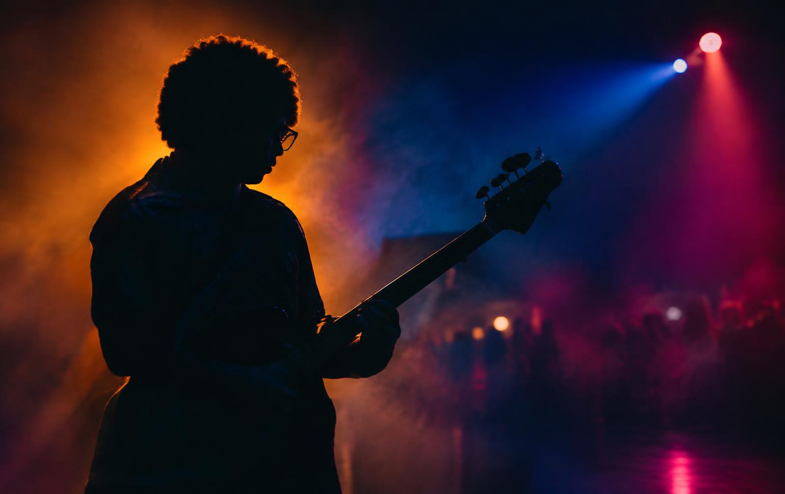 VIBE 7 performing on stage in warm and neon light